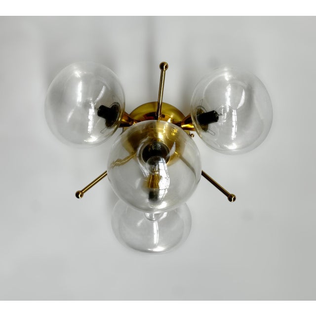 Italian flush mount with 4 clear pebble shaped Murano glass shades mounted on solid brass frame in lacquered polished...