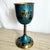 This vintage Israeli Kiddush cup is crafted in brass and finished with a rich blue enamel, accented by hand-painted...