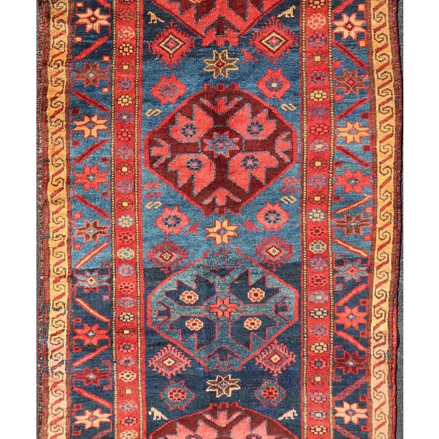 Measures: 4'0 x 9'1 Antique Kurdish Gallery Rug with Indigo Field and Bold Tribal Medallions. Keivan Woven Arts/...