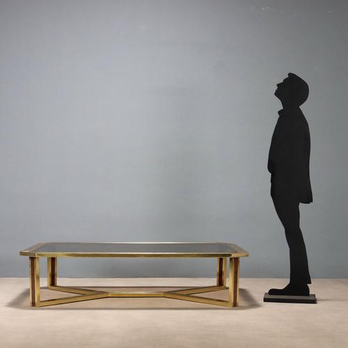 Coffee table with brass structure with burl inserts, rectangular shaped top in smoked glass. This piece is attributed to...