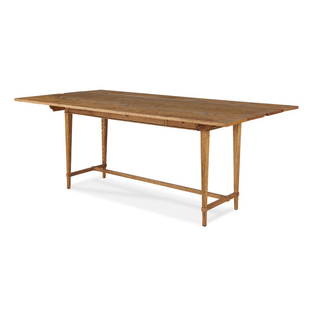 A refined console table balancing elegance and practicality, with a plank-style oak top, folding leaves, and three slim...