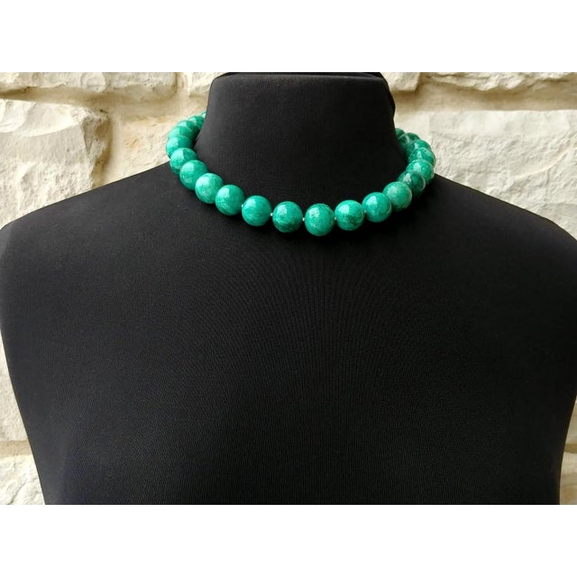 The length of the necklace is 18 inches (45.7 cm). The size of the smooth round beads is 16 mm. The beads' color is bright...