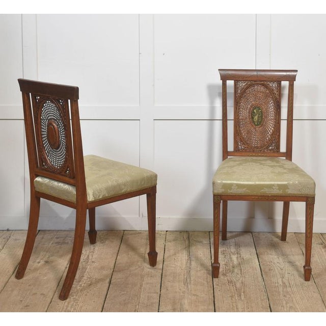 This refined pair of Edwardian side chairs is crafted in beautifully grained satinwood, prized for its warm honey tone and...