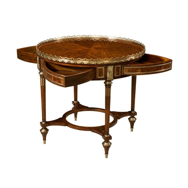A Louis XVI Mahogany Mechanical Center Table with solid mahogany and flame mahogany veneered mechanical center table, the...