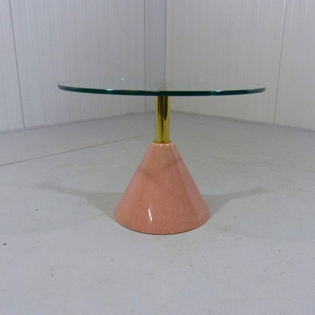 Lovely Itralian side table. Cone shaped foot of pink solid natural stone, Brushed brass stand and a thick glass table top....
