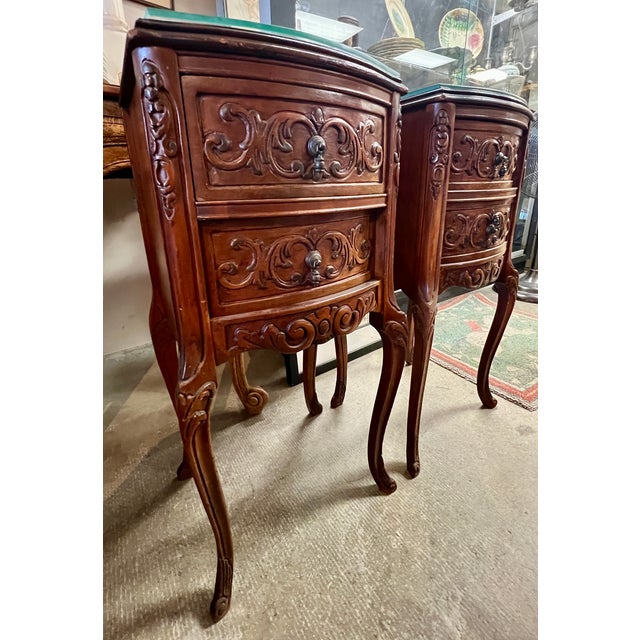 Vintage 1920s French-style end tables with ornate carvings on drawers. Three drawers in working condition. Can be used as...