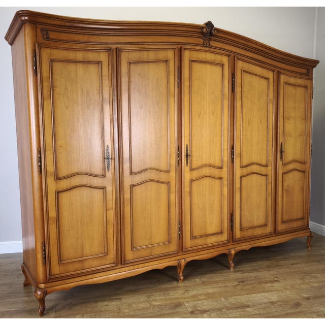 This impressive vintage French Louis style wardrobe makes a striking statement with its grand proportions, elegant five-...
