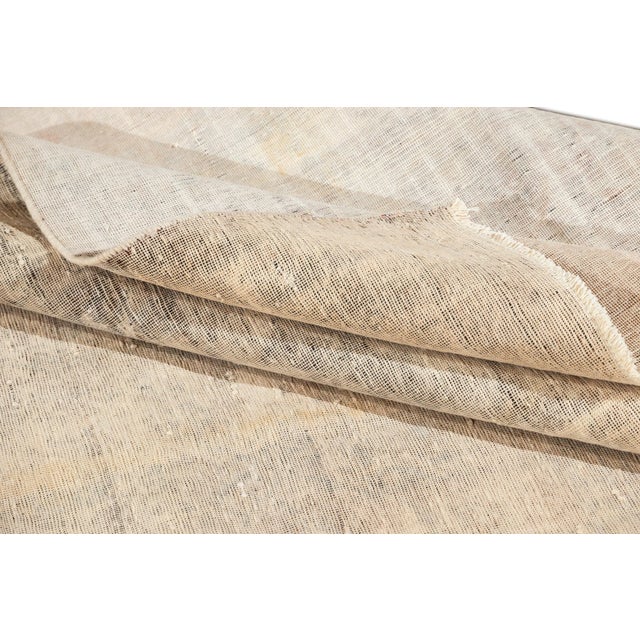 Vintage hand-knotted Persian carpet with an allover design on a distressed field. Material: wool Measures: 9' 4" x 14' 08"