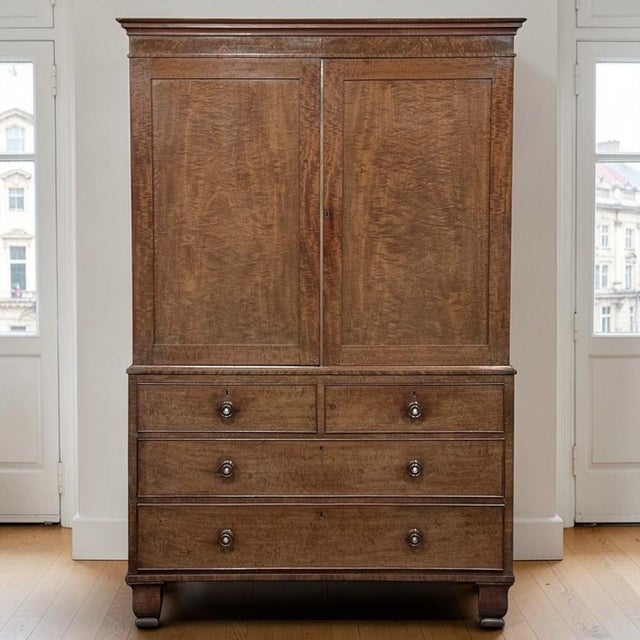 A beautiful example of early 19th century English cabinetmaking, this antique linen press combines refined simplicity,...
