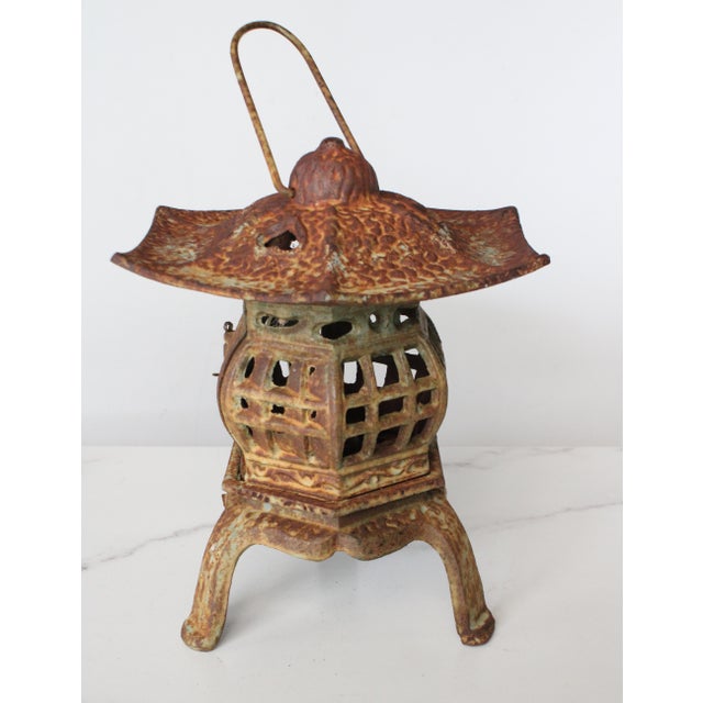 Circa 1940's Japanese iron pagoda garden candle lantern. Hand cast iron Japanese candle lantern with cut out heart...