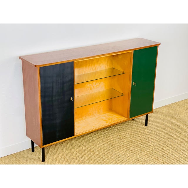 Tall sideboard, vintage teak and elm bookcase dating from the 1960s, featuring two storage doors and a niche with shelves....