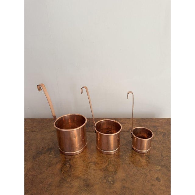 Quality set of three antique Victorian copper measures, having a quality set of three antique Victorian copper graduating...