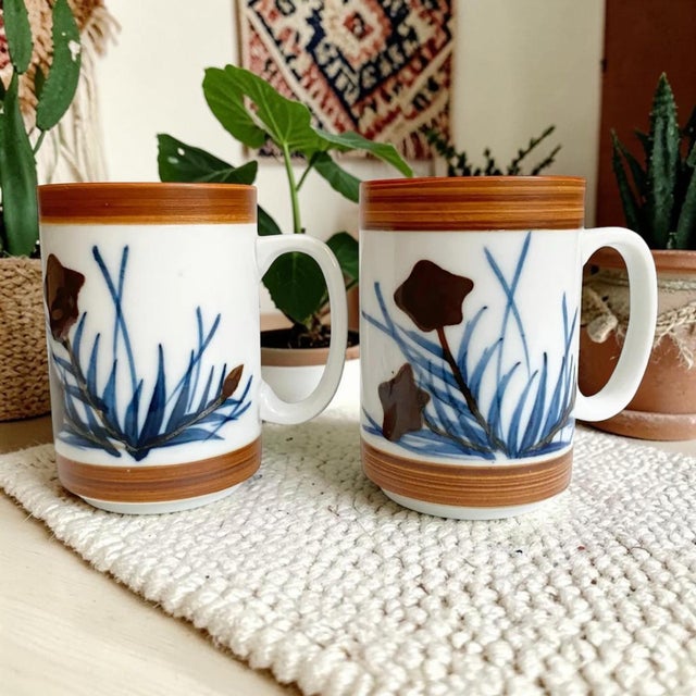 Elevate your coffee experience with the Holt Howard Stoneware Coffee Mug Set, featuring an exquisite abstract blue flowers...