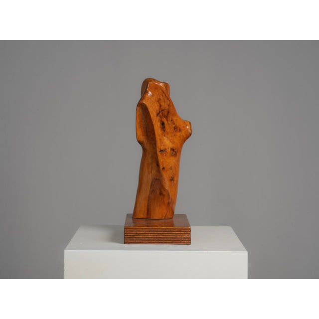 An expressive hand-carved sculpture by dutch artist h. Hinfelaar, created from pearwood. The elongated organic form...