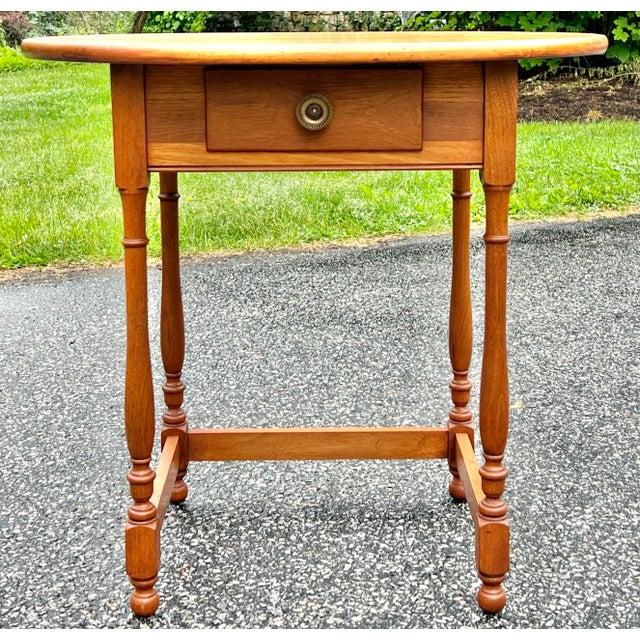Great little side or accent table originally used as a writing table. Crafted in walnut. A full width dovetailed drawer...