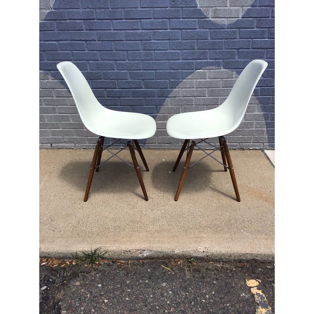 Pair of Eames-Style Molded Fiberglass Dining Chairs with Walnut Dowel Bases DSW An iconic pair of mid-century modern...