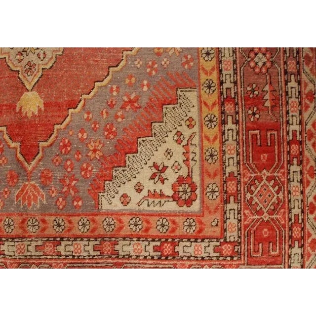 An antique Central Asian Samarkand rug with two large central diamond medallions with contrasting repeating diamond field,...