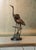 Bring the elegance of nature into your home with this cast alloy hand finished bronze sculpture. A pair of cranes show off...