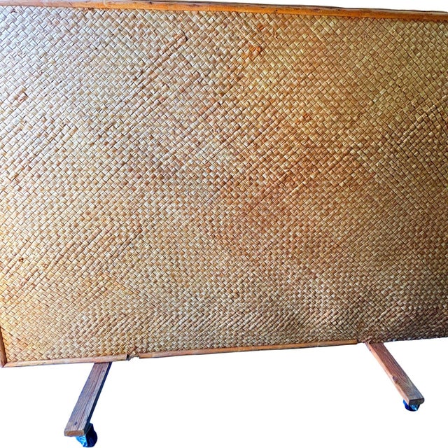 This beautifully restored coastal 1939 Rolling pole rattan room divider woven wall in the style of mid-century designers...