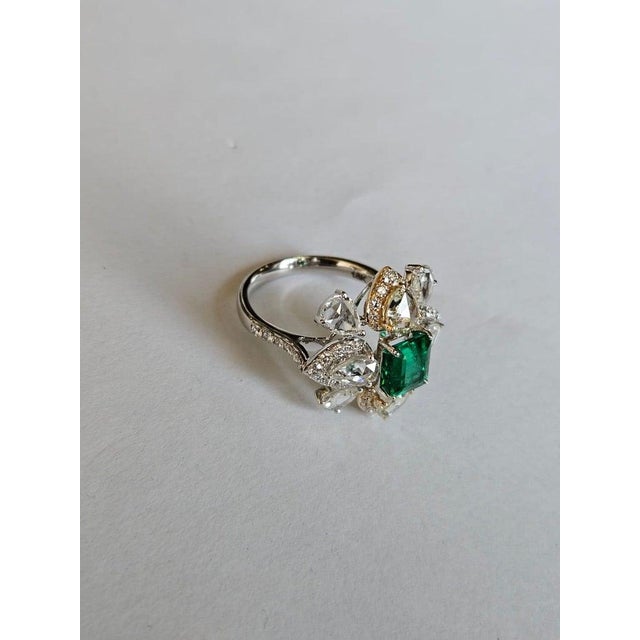 A very gorgeous and beautiful, modern style, Emerald Engagement Ring set in 18K White Gold & natural Diamonds. The weight...