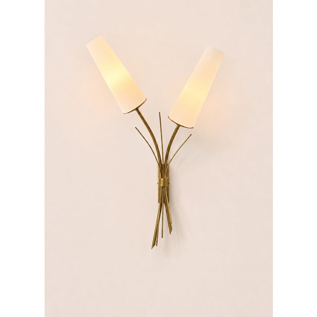 A significant pair of brass and opaline glass wall sconces, produced in France in the 1960s. Original design reminiscent...