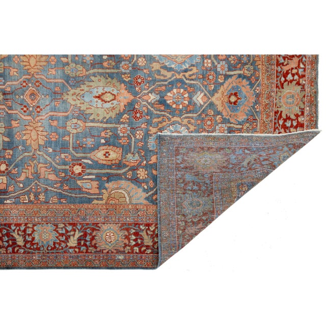 This Sultanabad rug, hand-knotted in the early 1900s, showcases the timeless artistry of Persian weaving. Crafted from...