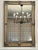 Soft gold paint with a light gray wash encompasses this French Provincial style wall mirror. The mirror is surrounded by a...