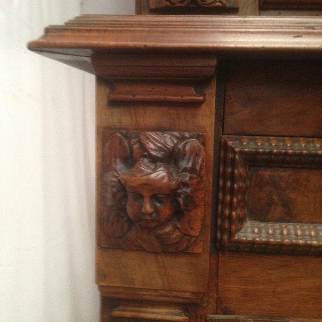 Solid walnut four-leaf cabinet 18th century period Decorated with angel and lion heads Good overall condition / Sold in...
