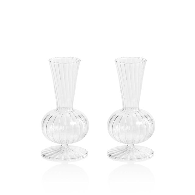 This elegant footed vase combines classic design with contemporary appeal. Crafted from clear glass, it features a...