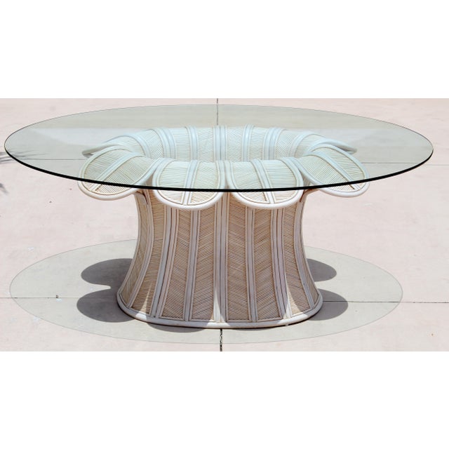 Bring timeless tropical sophistication into your home with this exceptional vintage pencil reed rattan dining table from...