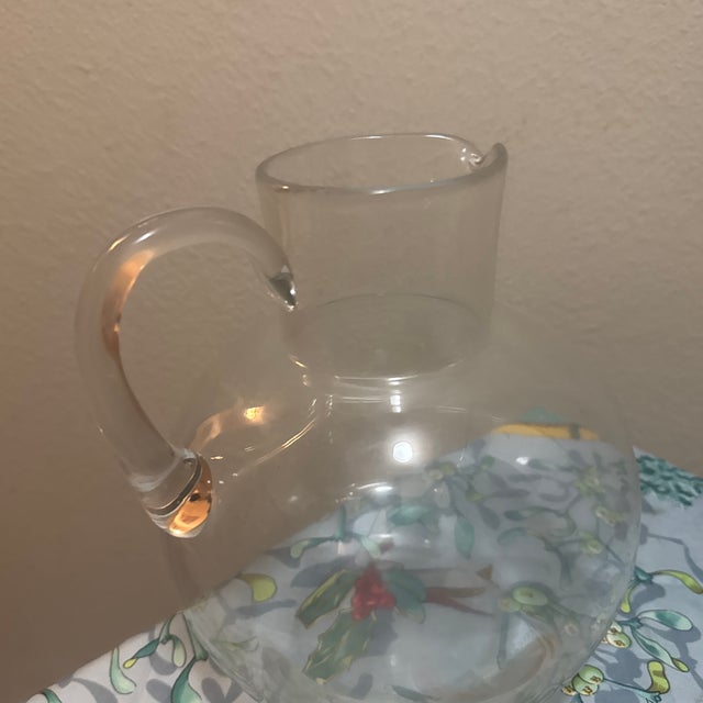 Elegant Tiffany & Co. glass water pitcher with a classic, refined silhouette. Beautifully suited for entertaining or...