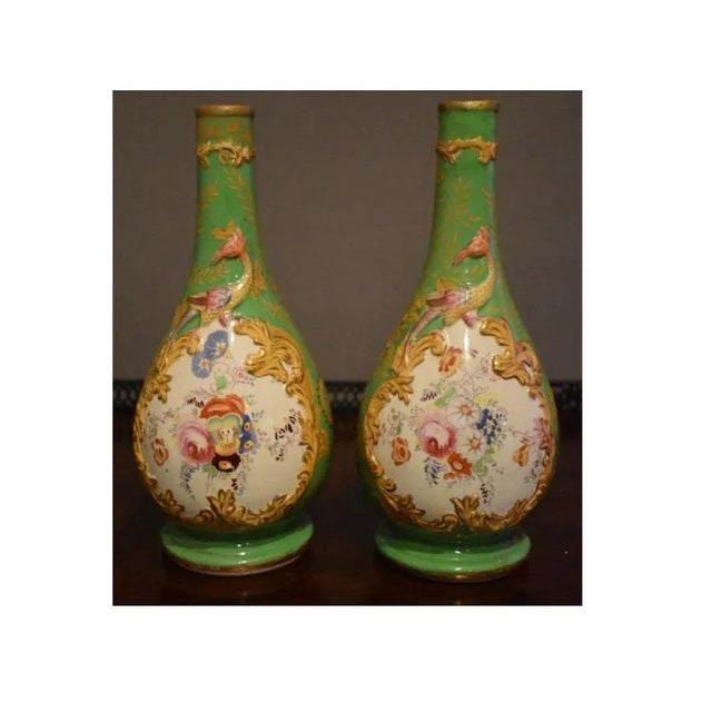 Pair of continental viewers, mid 19 century. on a yellow-green ewers. The highly detailed floral decorations are...