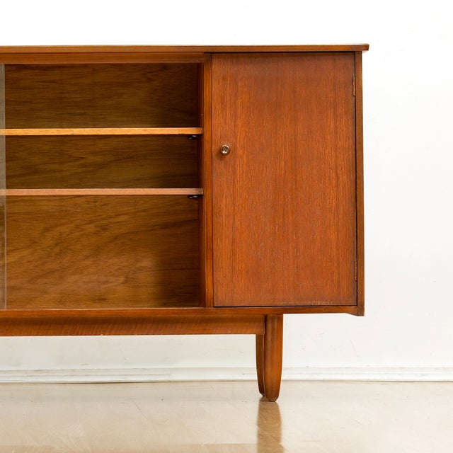Mid Century cabinet produced in England during the 1960s. A wonderful design and excellent storage piece. Made from teak,...