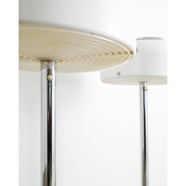 A rare and iconic pair of Swedish mid century floor lamps model "Knubbling" in chrome and white acrylic plastic designed...