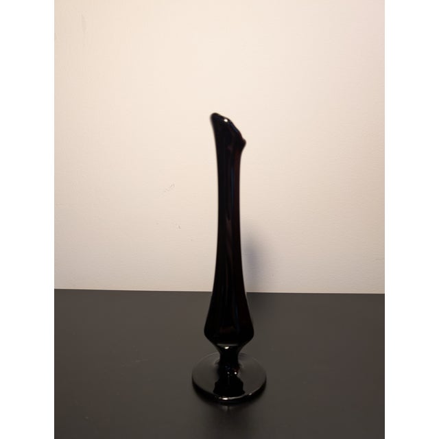 This black mid century modern swung glass bud vase stands about 8.5" tall and provides an elegant accent in your room. It...