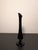 This black mid century modern swung glass bud vase stands about 8.5" tall and provides an elegant accent in your room. It...