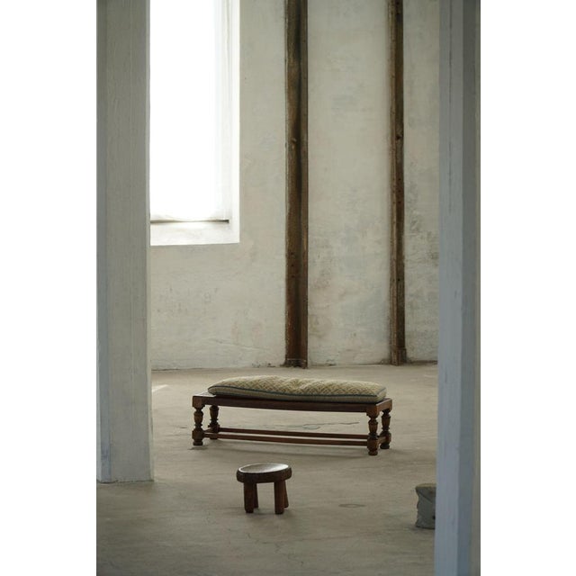 A charming mid-20th century Danish oak footstool, dating from the 1940s–1950s. The bench features a sturdy frame with...