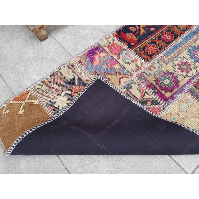 This is a vintage Turkish Oushak rug from the Mid 20th Century. The piece was hand-knotted.