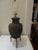 A unique Pottery Lamp that rests on a wrot Iron base with Iron rings on each side.