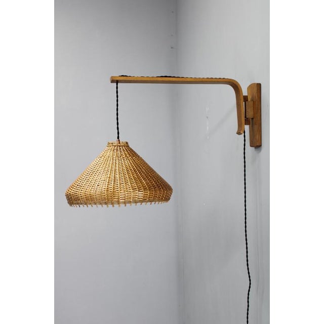 An original adjustable wooden wall light designed and produced in czechoslovakia during the 1970s by dřevopodnik holešov,...