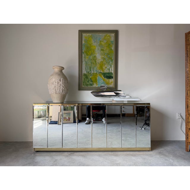 Striking 1970’s Hollywood Regency credenza by Ello, featuring a glamorous combination of polished brass framing and...