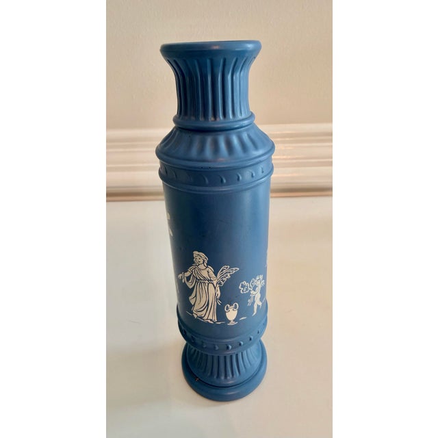 Elegant vintage blue and white ceramic vase in the Neoclassical jasperware tradition, featuring classical figural scenes...