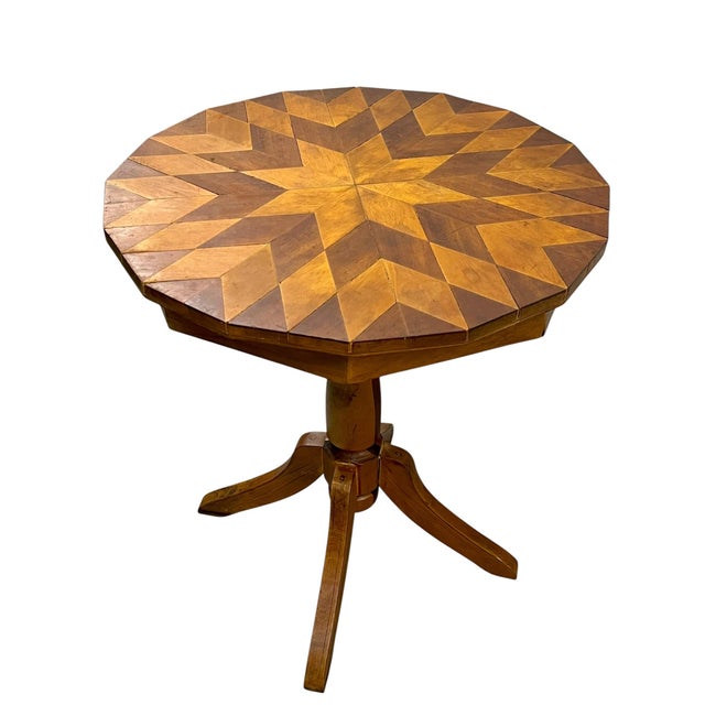 A striking vintage handcrafted marquetry pedestal table featuring an extraordinary geometric starburst top inspired by...
