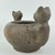 Striking hand-made ceramic pot featuring two stylized "cats" emerging from the rim. The rounded body and sculptural form...