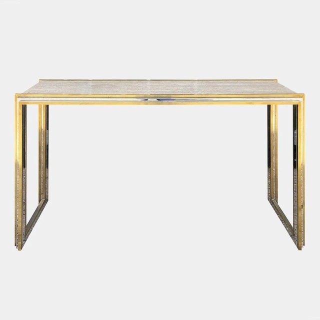 A large console table in brass and chrome with a polished Italian Travertine stone top. Good scale and form. The stepped...