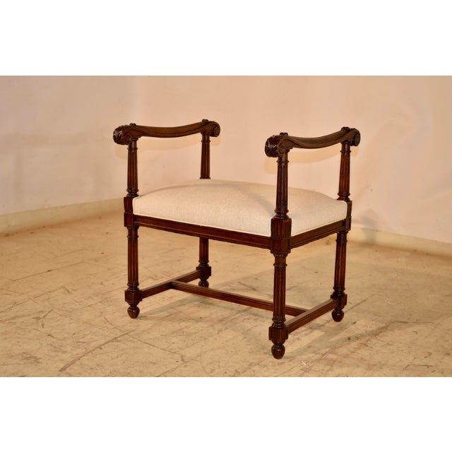 19th century French bench with arms. The frame is made from walnut, and has two hand carved and shaped scrolled arms,...
