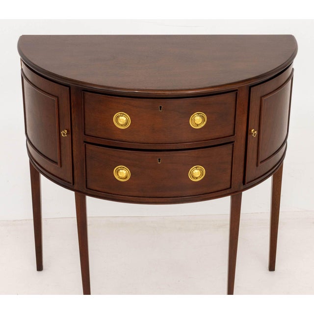 Baker Furniture Historic Charleston Collection Mahogany Demilune Console Table, with two central drawers flanked by semi-...