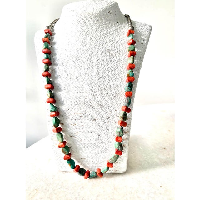 Stunning, long vintage turquoise and coral Native American beaded necklace with sterling silver clasp. Length: 28”
