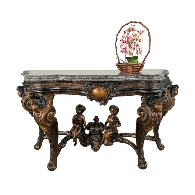 Bronze console table with an ornate figural base and shaped granite stone top. The table is designed in a grand French...