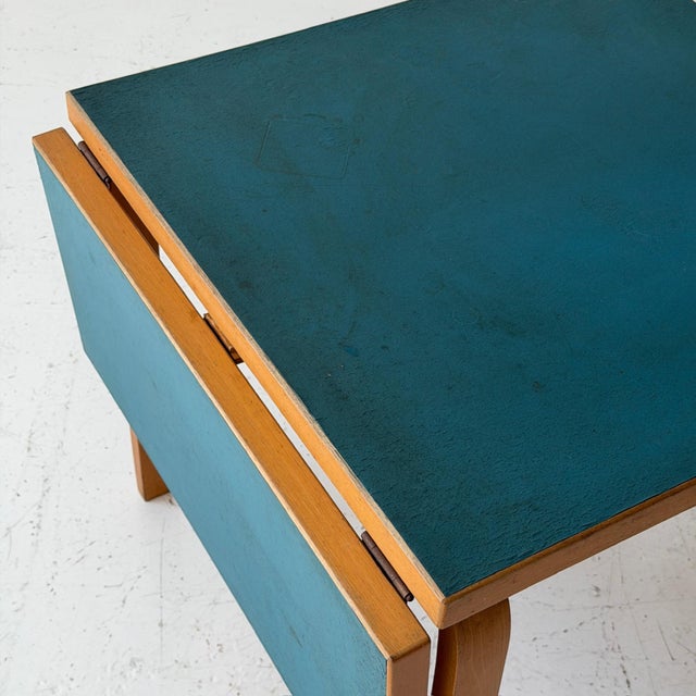 c. 1950s. Finland. Blue Linoleum top with birch frame and adjustable leaf. Dimensions without leaf: 30L 30W 28H